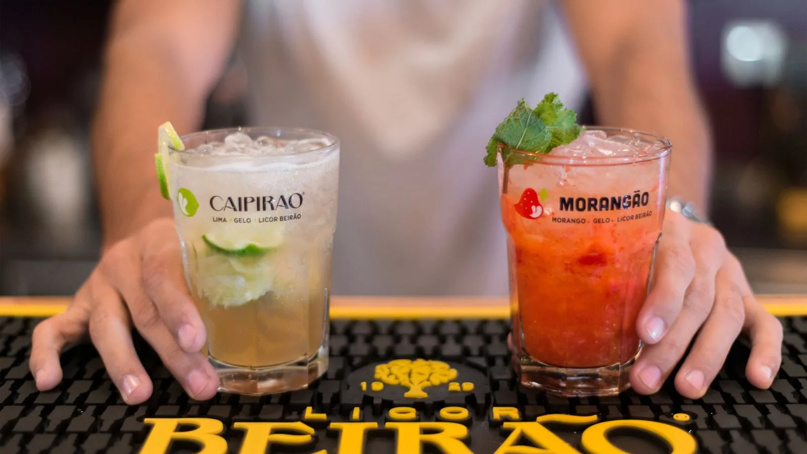 Close-up of refreshing cocktails with mint and lime at a bar in Porto, ideal for summer parties.