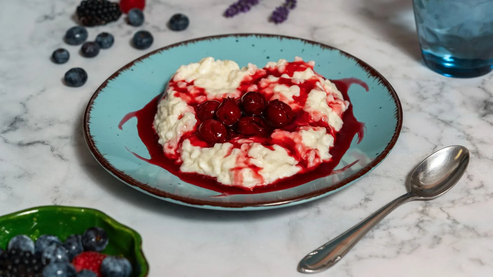 Delicious rice porridge with cherries and berries on a plate, perfect food photography for breakfast ideas.