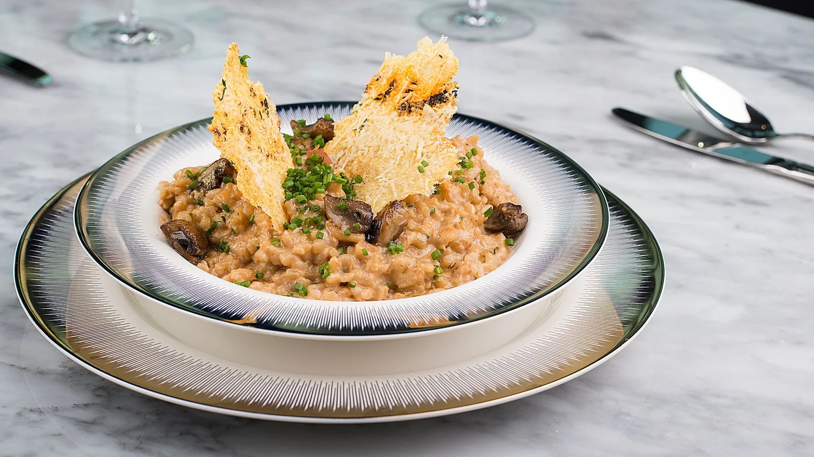 Delicious mushroom risotto served in an elegant setting with crispy toppings.