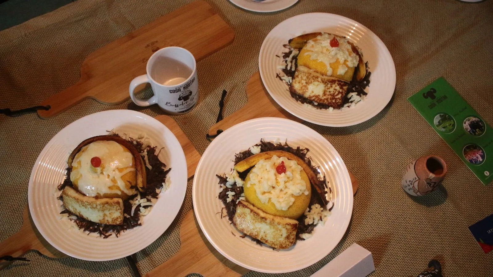 Overhead view of traditional polenta dishes served on plates with wooden boards and a rustic setting.