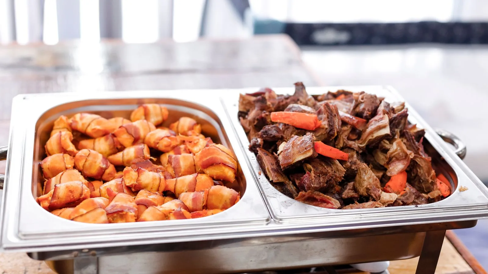 Delicious buffet with bacon wrapped potatoes and roast beef, perfect for any meal.