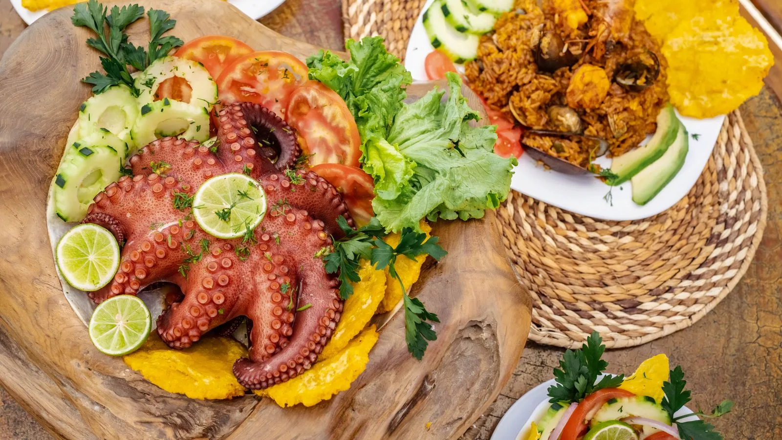 Delicious seafood platter with octopus and vegetables, presented on a rustic wooden board.