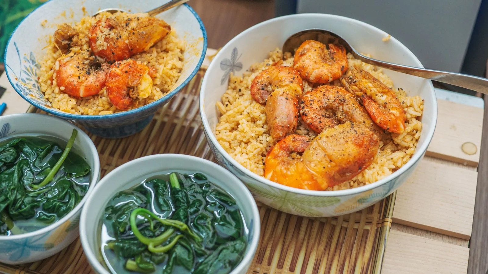 Savor the taste of shrimp and rice bowls paired with fresh spinach soup, perfect for seafood lovers.