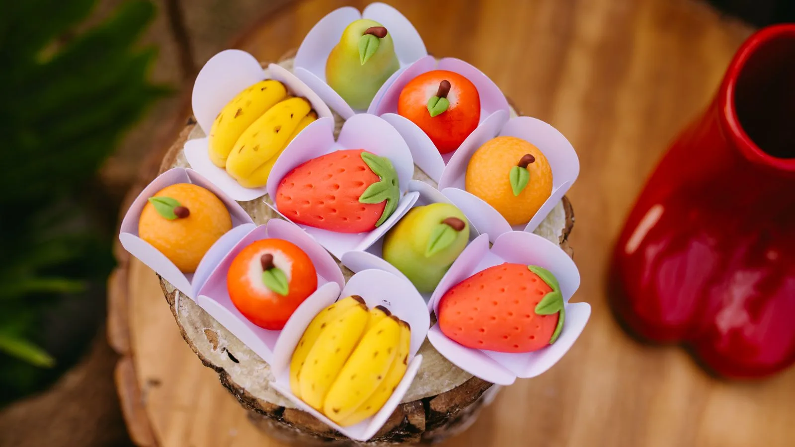 A vibrant assortment of fruit-shaped confectioneries presented on a wooden surface, exuding a playful and artistic vibe.